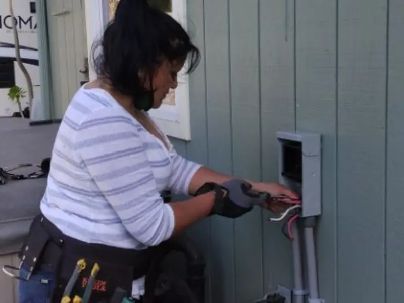 Licensed electrician wiring an exterior subpanel in Mississippi State